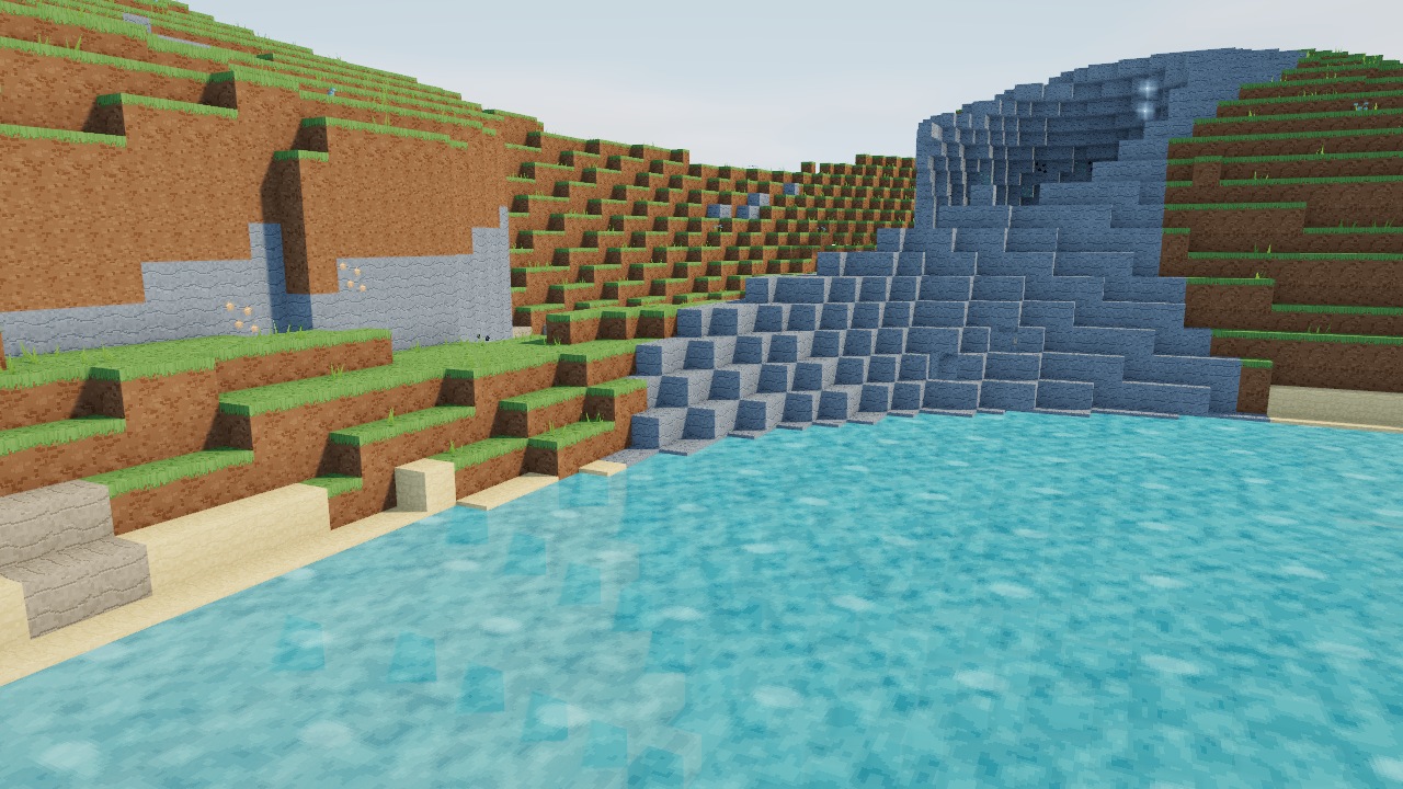 Animated pixel water beside a stone and grass shoreline